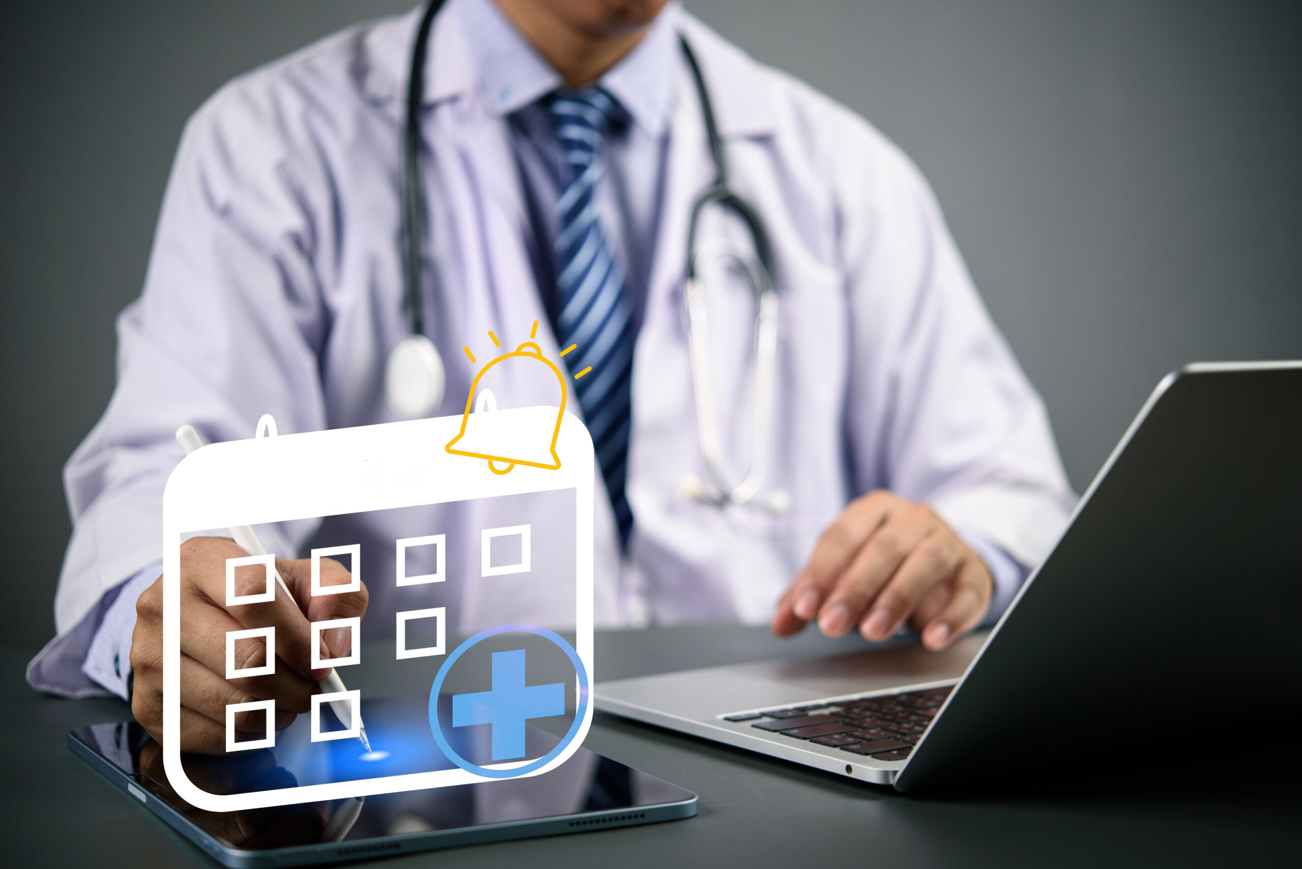 Doctor,Using,Digital,Tablet,And,Laptop,With,Medical,Appointment,Calendar